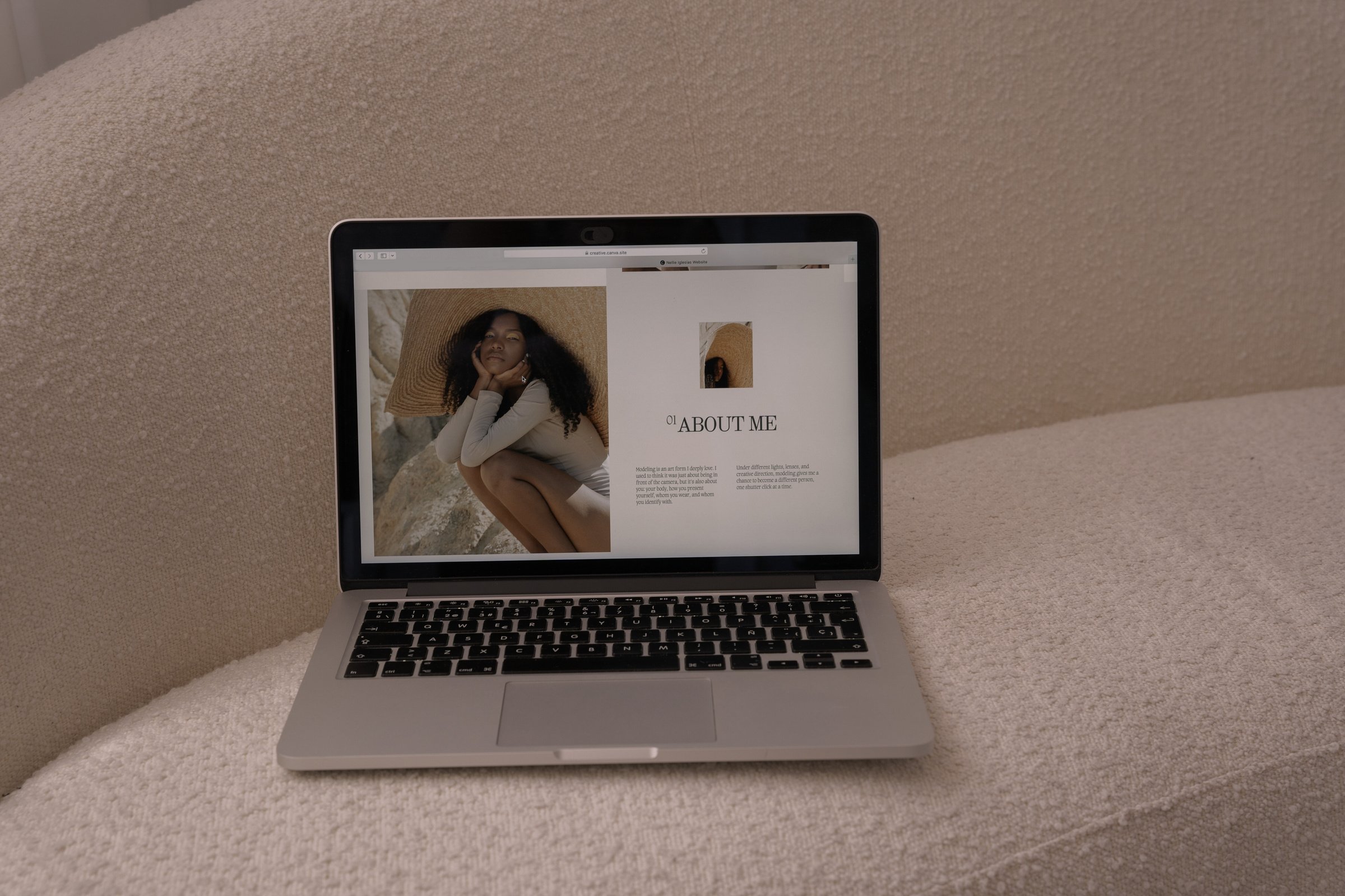 a laptop sitting on top of a white couch